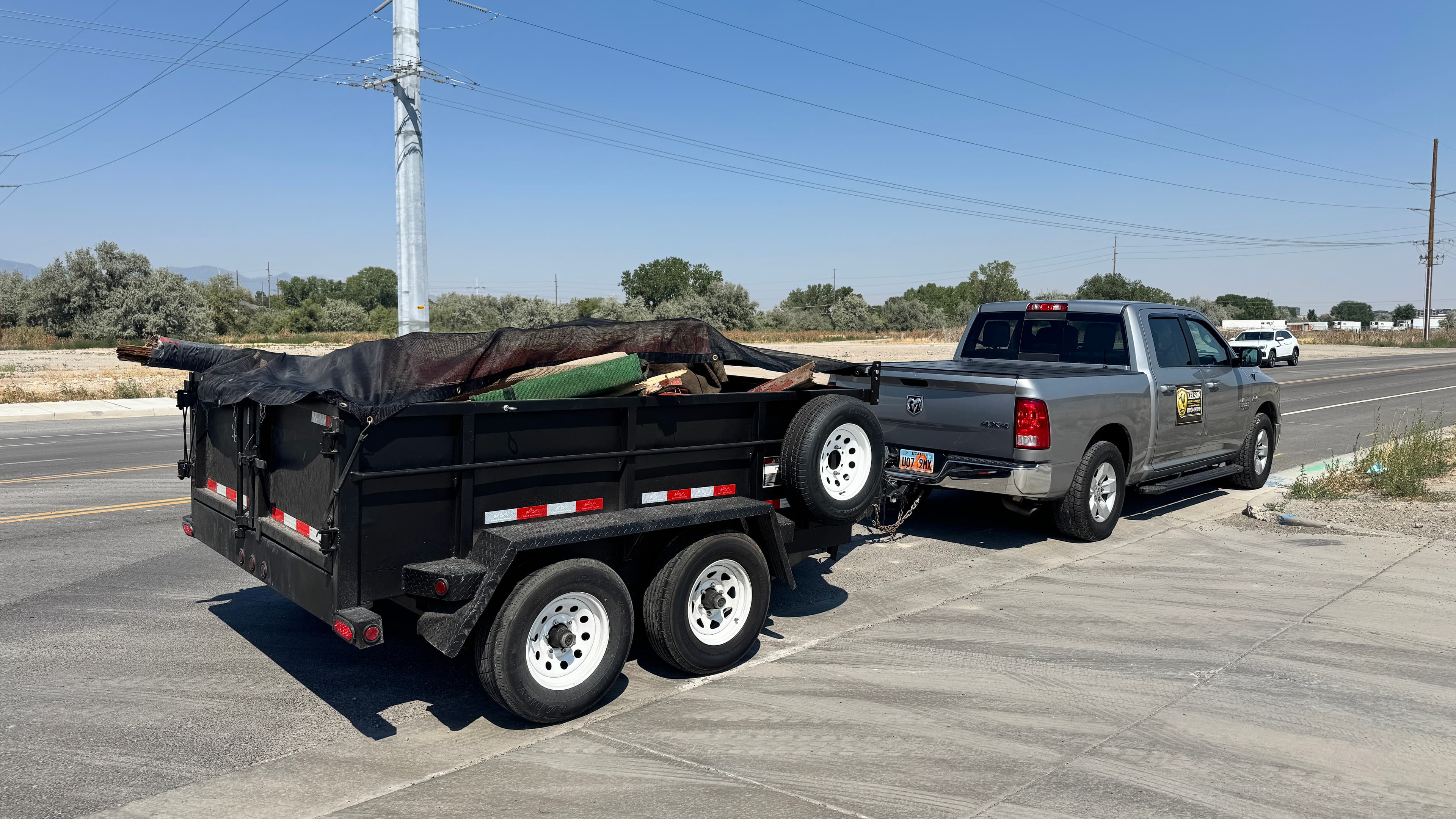Kelson Hauling & Landscape truck and trailer ready for junk removal and property cleanout work
